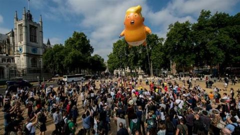 protesters flying a giant inflatable baby